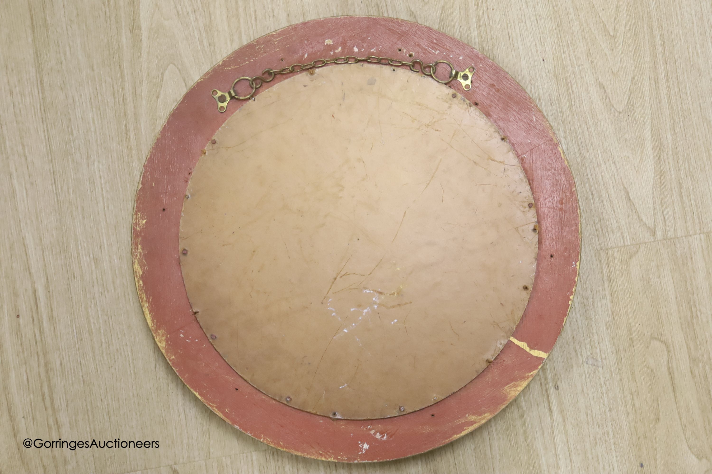 A circular gilt convex wall mirror, overall diameter 85cm